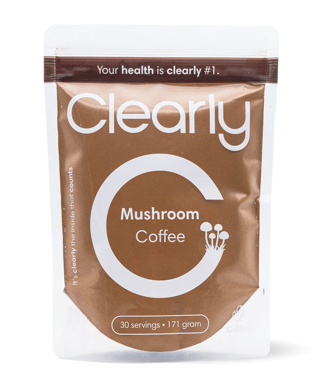 Clearly mushroom coffee in a mug with a spoon, showcasing the front view of the herbal coffee beverage.