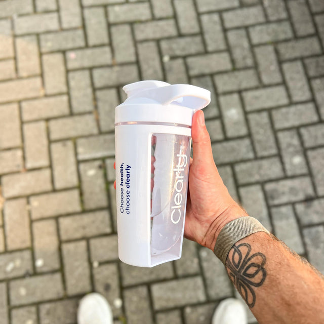 Clearly shaker bottle shown outside view, featuring a sleek design, secure lid, and durable construction for mixing beverages.